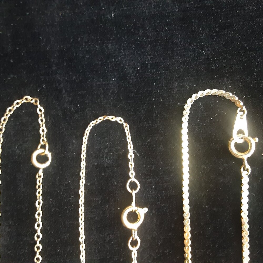 three thin gold necklace chains